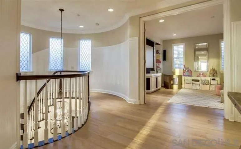 Second floor view of stairs and fully equipped theater room
