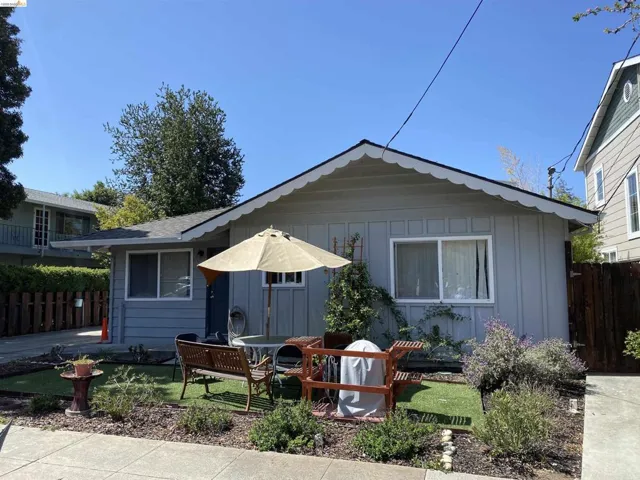 Back of house with board and batten siding and a patio area