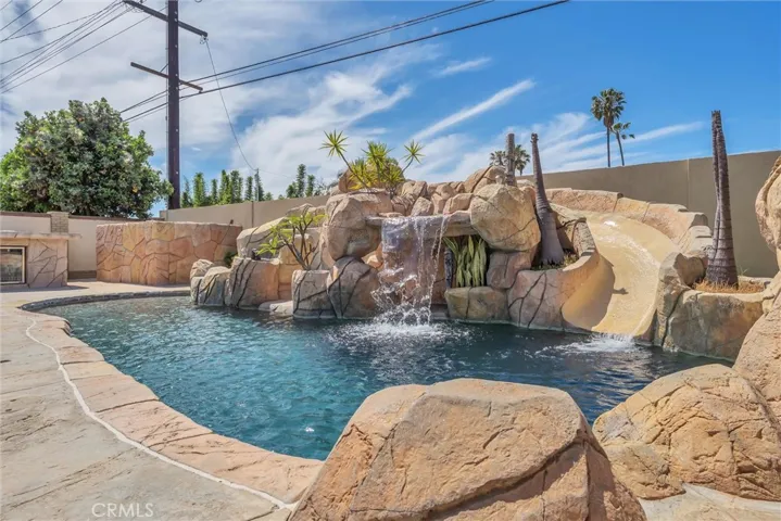 Enjoy a stunning built-in saltwater PebbleTec pool — perfect for relaxing or entertaining and I have a slide too!
