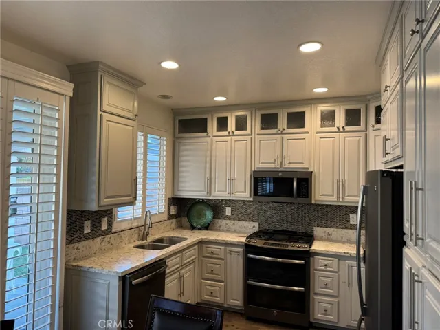 Kitchen w/stone countertops and built in appliances