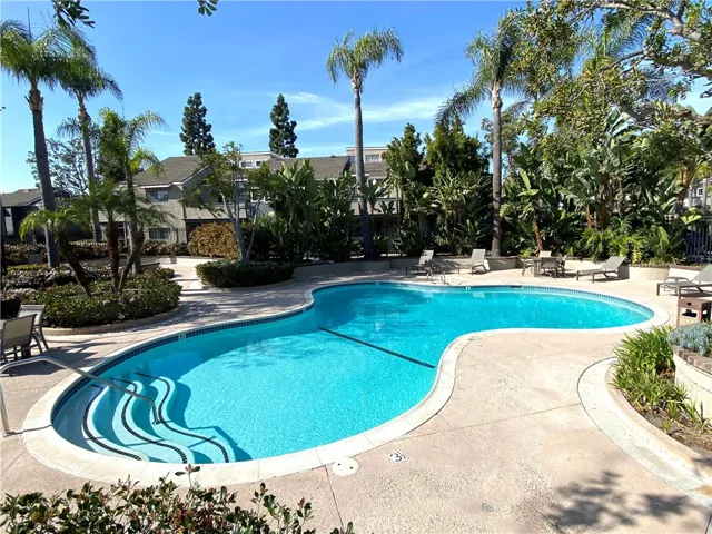 The lush tropical garden offers a resort-style living experience.