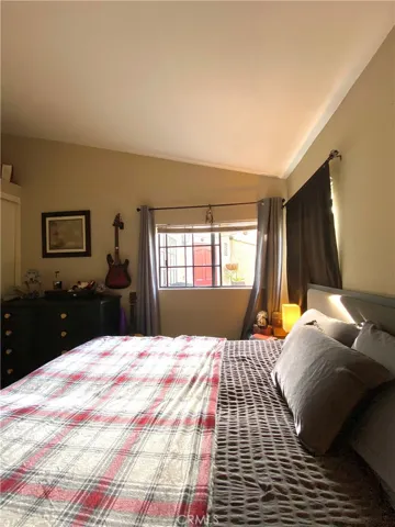 The downstairs cozy bedroom has vaulted ceilings.