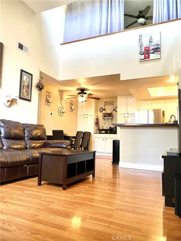 The open floor plan living room has very high, vaulted ceilings.