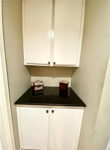 Built in linen cabinets with black granite and oversized deep bottom cabinet.