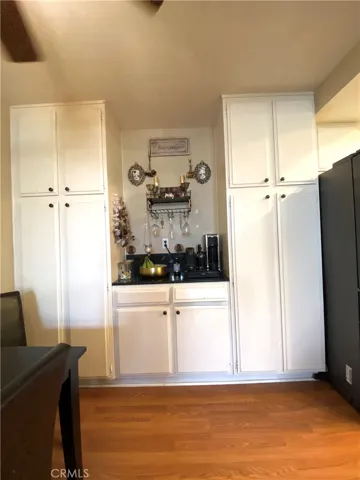 There are floor-to-ceiling cabinets for extra storage, as well as a small bar/serving area.