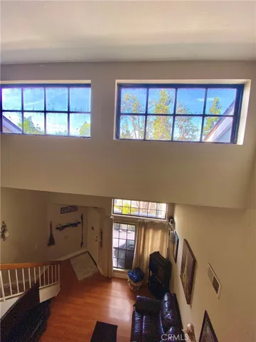 The wide windows offer a tranquil view of the treetops and open space.