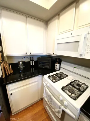 The kitchen features a gas stove, a extra deep bottom cabinet biult-in microwave, and an extra-deep cabinet with ample counter space.