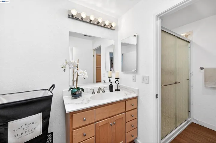 A full bath with stackable W/D area