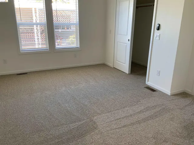 Unfurnished bedroom with carpet and a closet