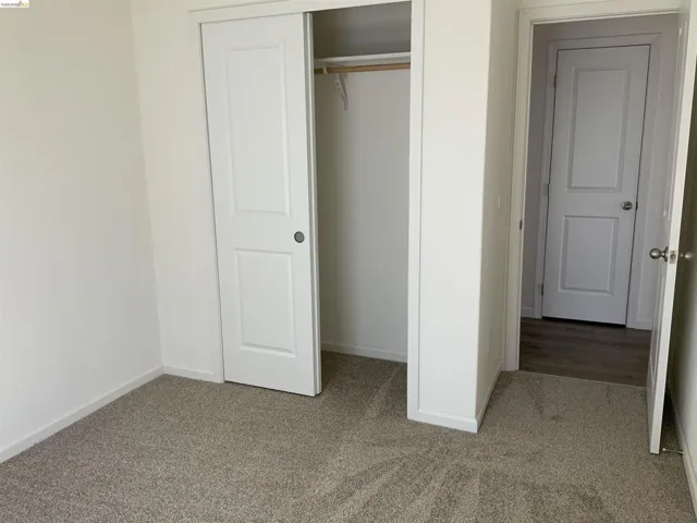 Unfurnished bedroom featuring carpet and a closet