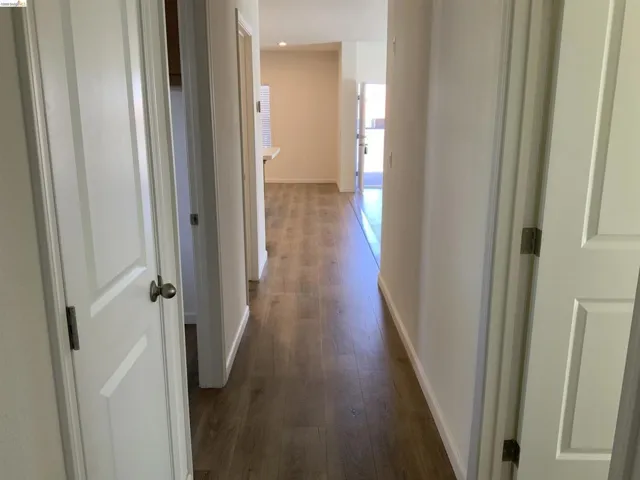 Corridor featuring dark wood finished floors and recessed lighting