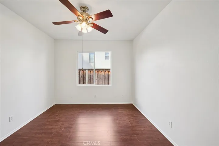 Spacious second bedroom with ceiling fan