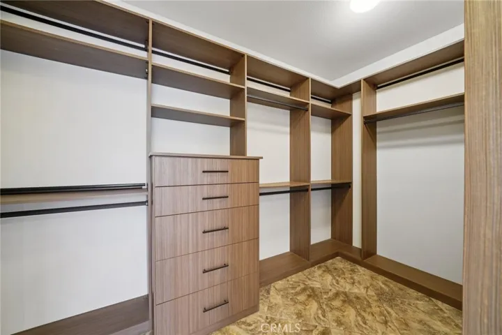 Walk-in closet with custom shelving and organization