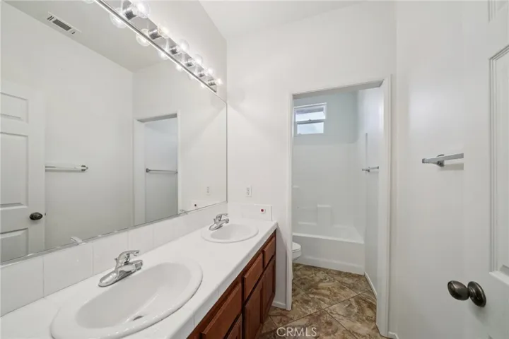 Spacious secondary bathroom with dual vanities