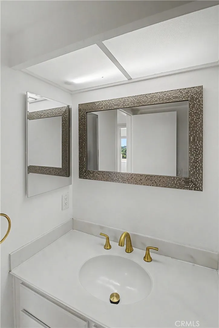Bathroom has an additional 1/4 bath sink area to make sharing more convenient.