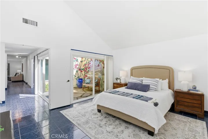 Primary bedroom with sliding door access to the atrium