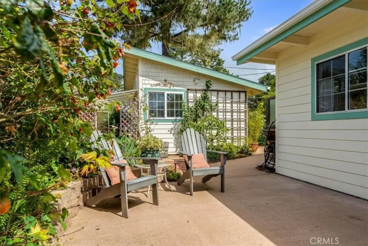 Patio leads to backyard and guest cottage.