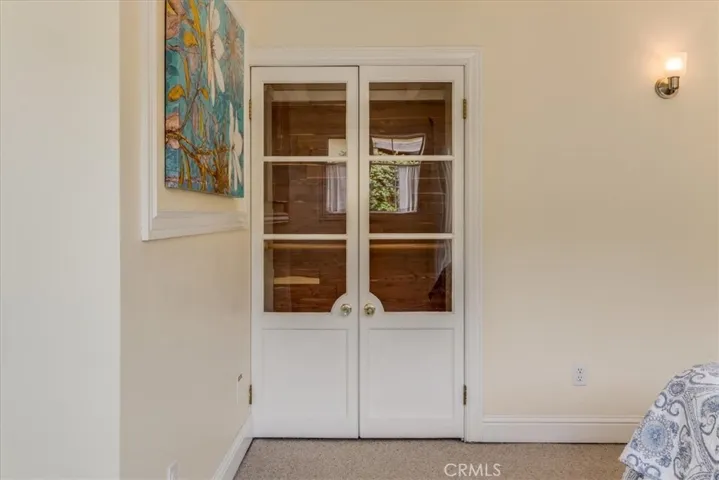 The closet has charming glass doors.