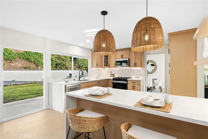 Custom lighting including under-cabinet illumination, and a full suite of brand-new appliances