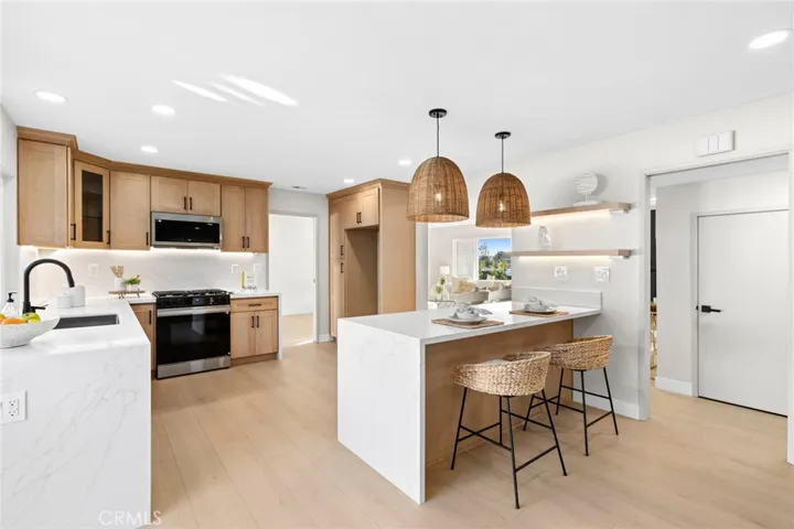 Featuring quartz countertops with a dramatic waterfall edge