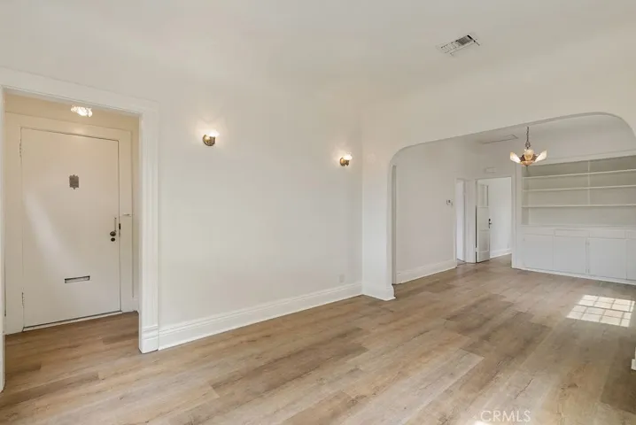Living room with coved ceiings and dining room
