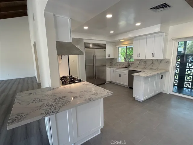 Gorgeous remodeled Kitchen w/Sub Zero refridgerator.  Breakfast bar, recessed lighting