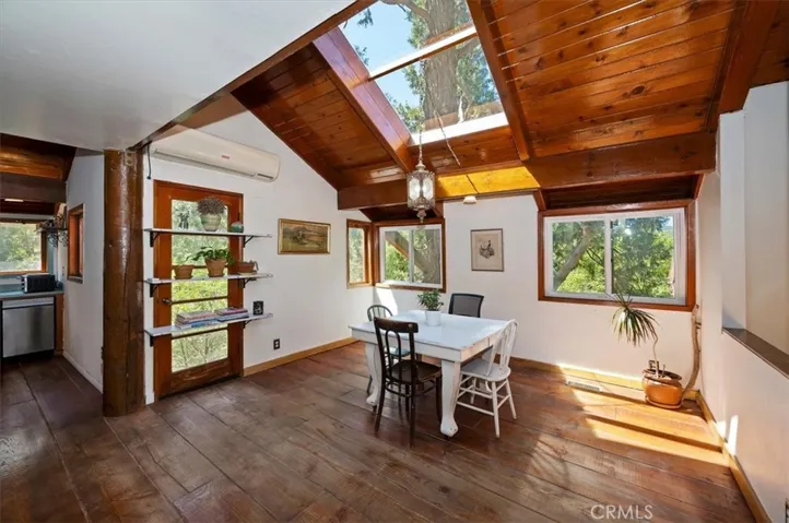 Dining area showing hardwood floors and Large skylight