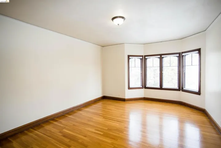 Spare room with light wood finished floors and crown molding