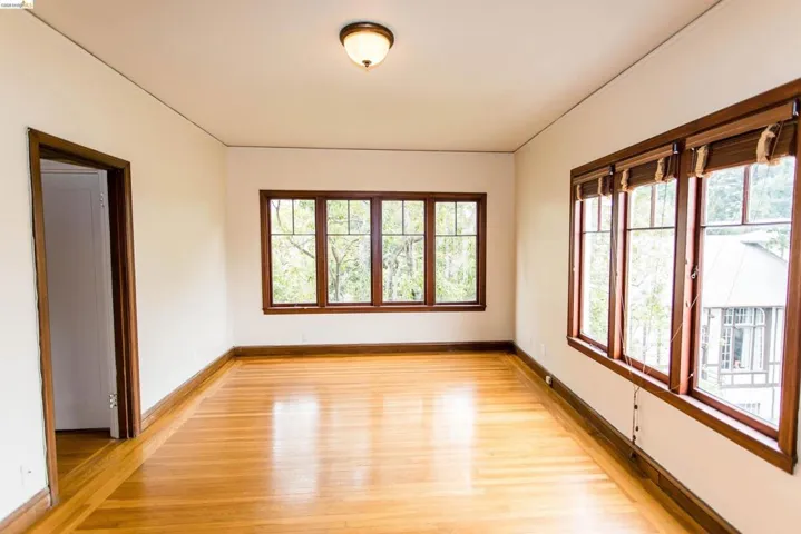 Empty room with baseboards and light wood-style flooring