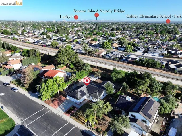 Aerial view of property's location featuring nearby suburban area