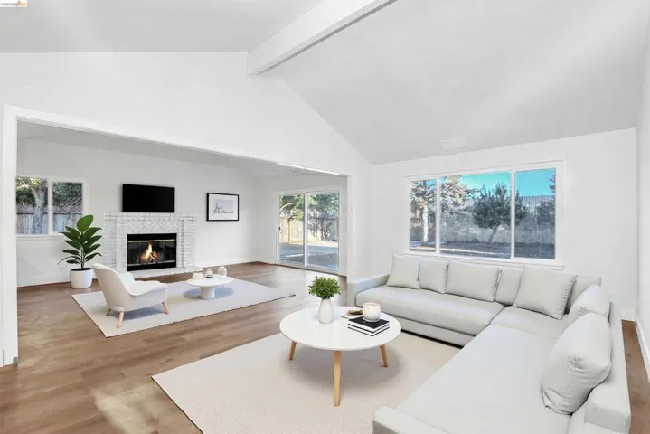 Living room featuring light wood finished floors and a brick fireplace