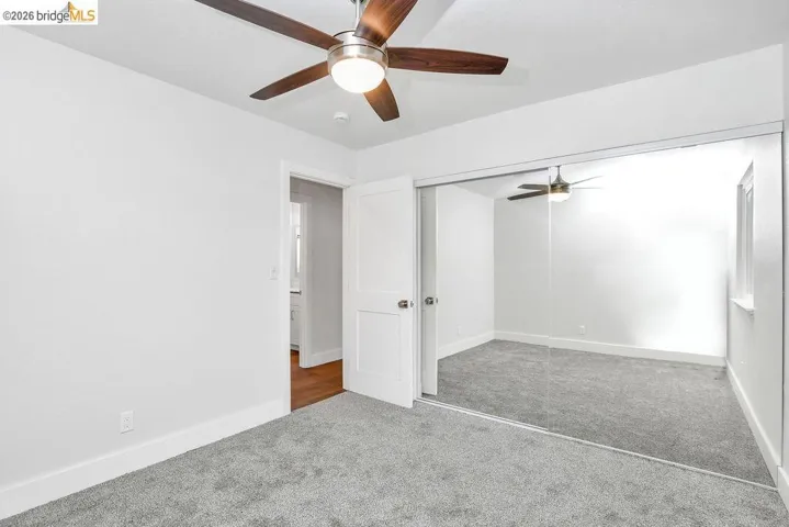 Unfurnished bedroom with carpet flooring, a closet, and ceiling fan