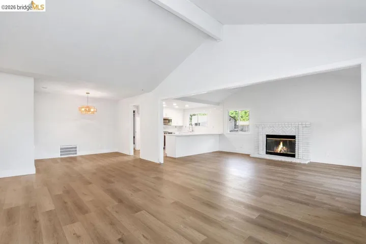 Unfurnished living room with a fireplace and light wood-style flooring