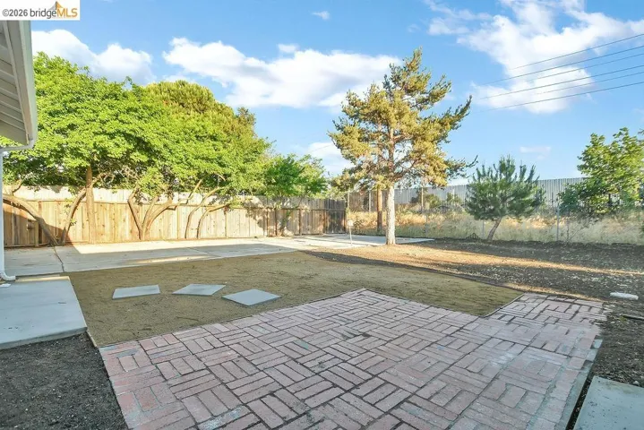 Fenced backyard with a patio area