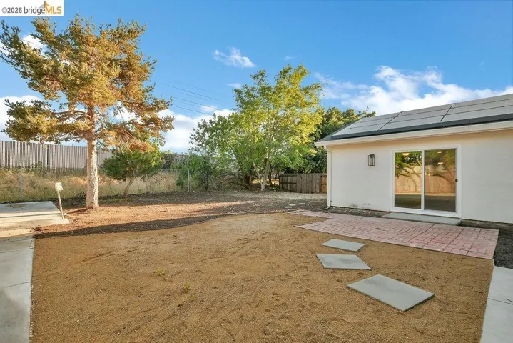 Fenced backyard with a patio area