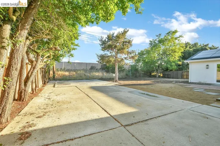 Fenced backyard featuring a patio