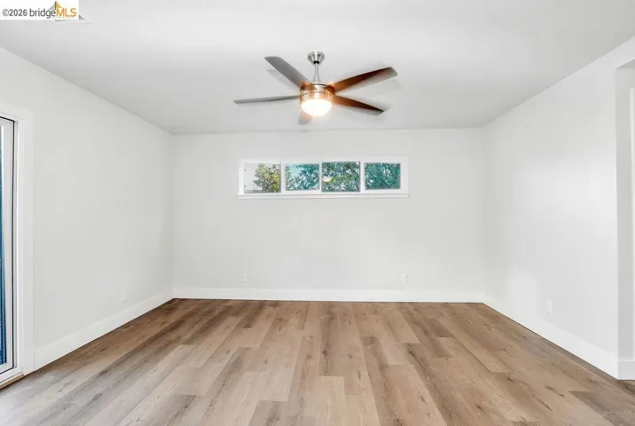 Spare room featuring light wood-type flooring and a ceiling fan