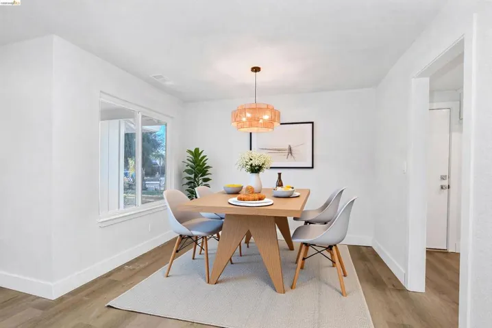 Dining area with baseboards and light wood-style flooring
