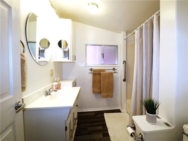 Sparkling clean bathroom with bathtub/shower and extra storage cabinets