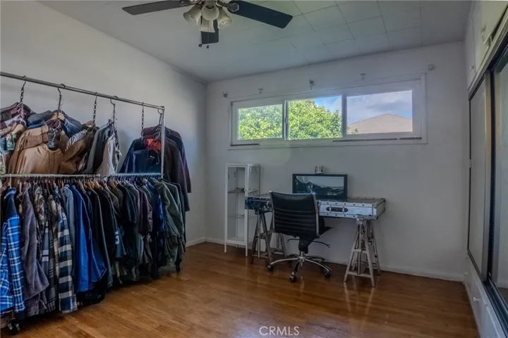Second bedroom with wood flooring and flexible layout