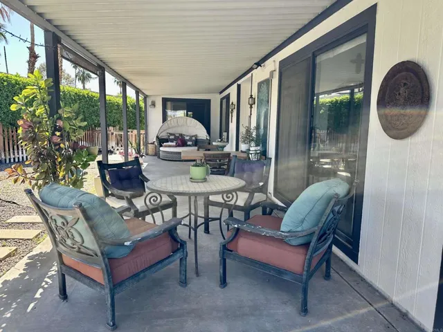 Long covered patio and yard that is fully fenced.