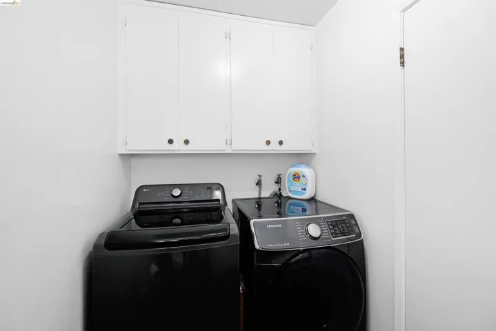 Laundry room with cabinet space and washer and dryer