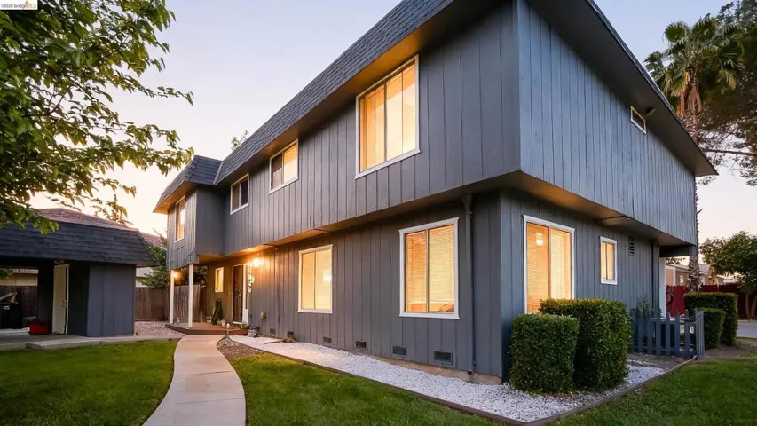 Back of house at dusk featuring crawl space