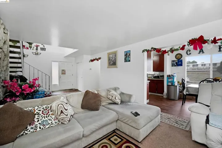 Living room with stairs and wood finished floors