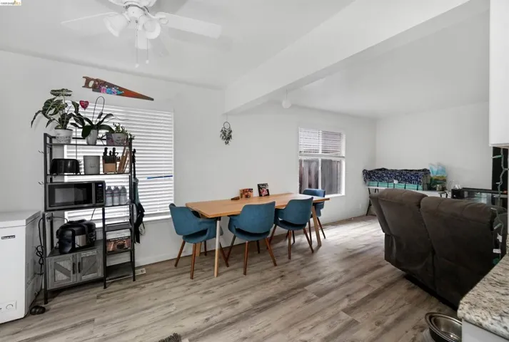 Dining area with ceiling fan and light wood-style floors