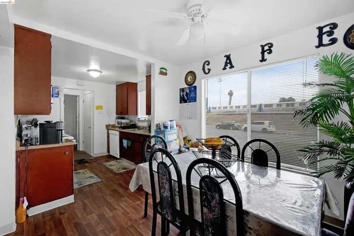 Dining area featuring dark wood-style flooring and a ceiling fan