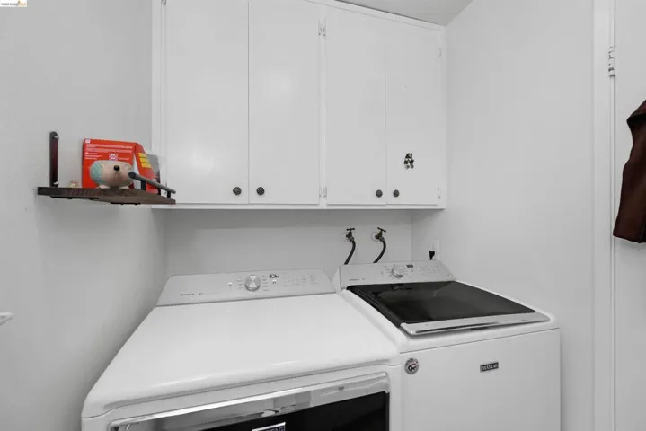 Laundry room with washer and dryer and cabinet space