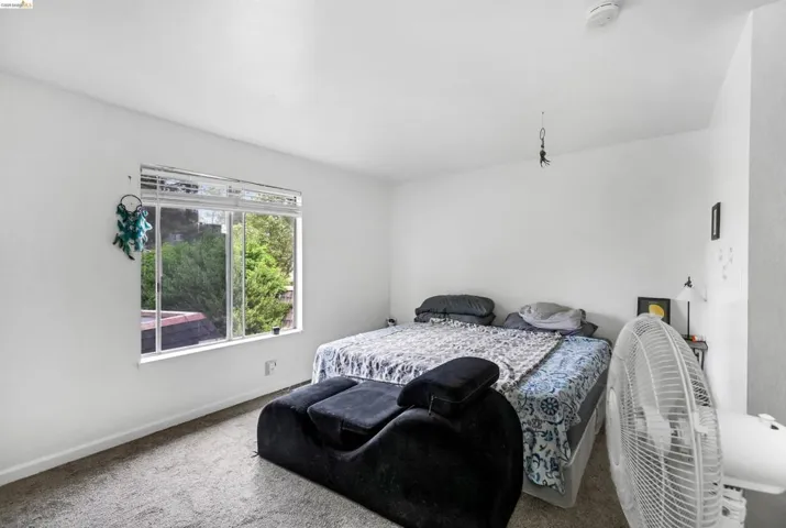 Bedroom with carpet floors, abundant natural light