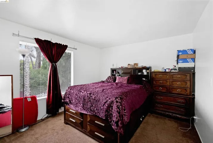 Bedroom featuring dark carpet