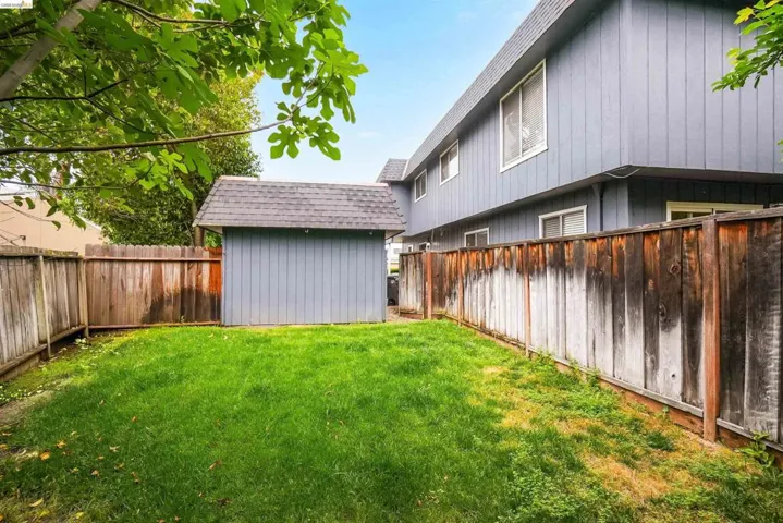Fenced backyard with a storage unit